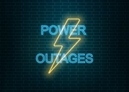What is the difference between a blackout and a brownout in electricity terms?